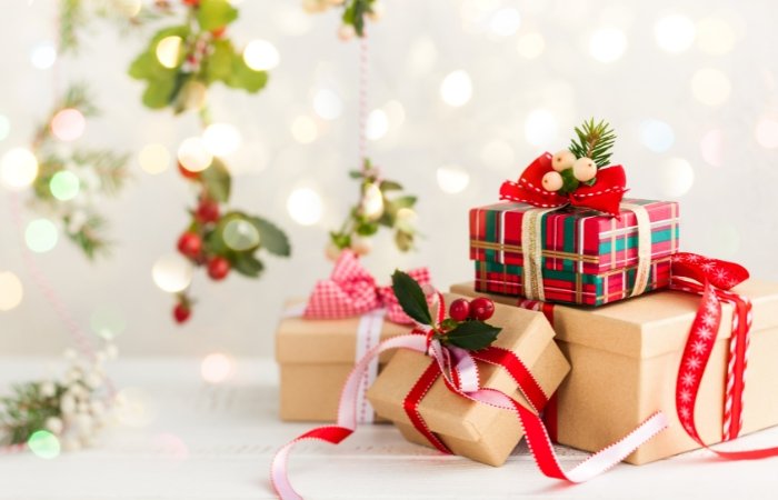 Presents on a white background with sparkling lights and christmas decorations. Blog post featured image.